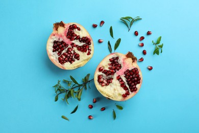 Photo of Flat lay composition with ripe pomegranate on light blue background