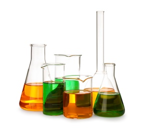 Laboratory glassware with colorful liquids on white background