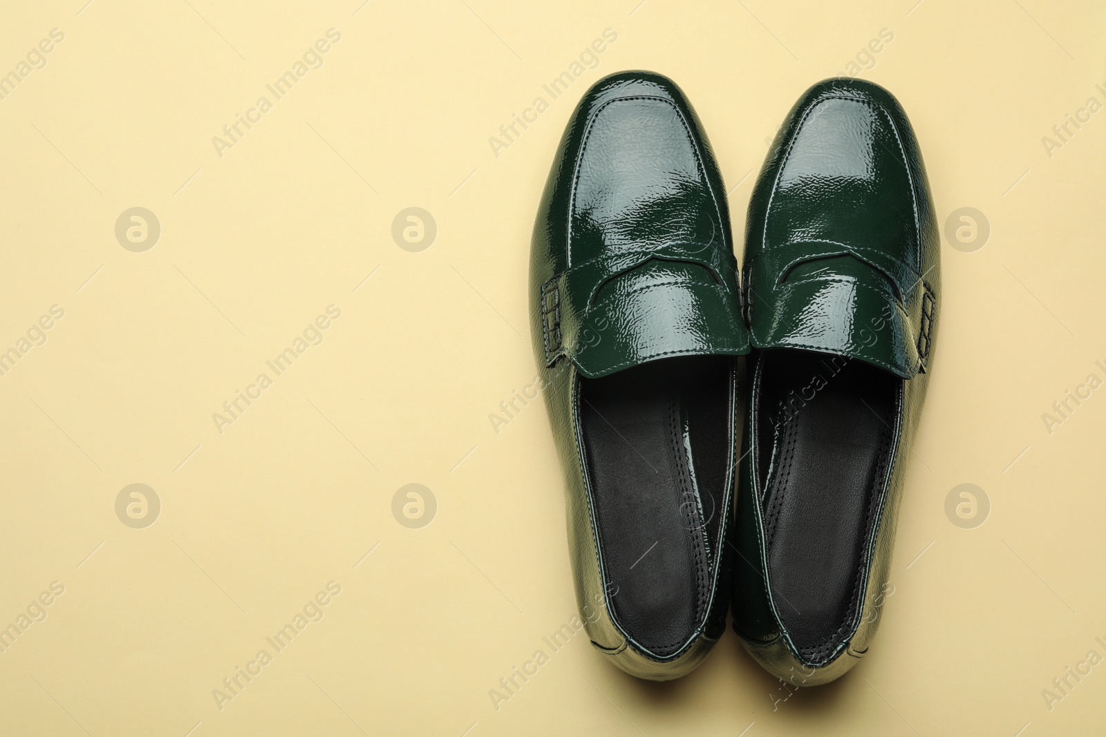 Photo of Pair of stylish female shoes on yellow background, top view. Space for text