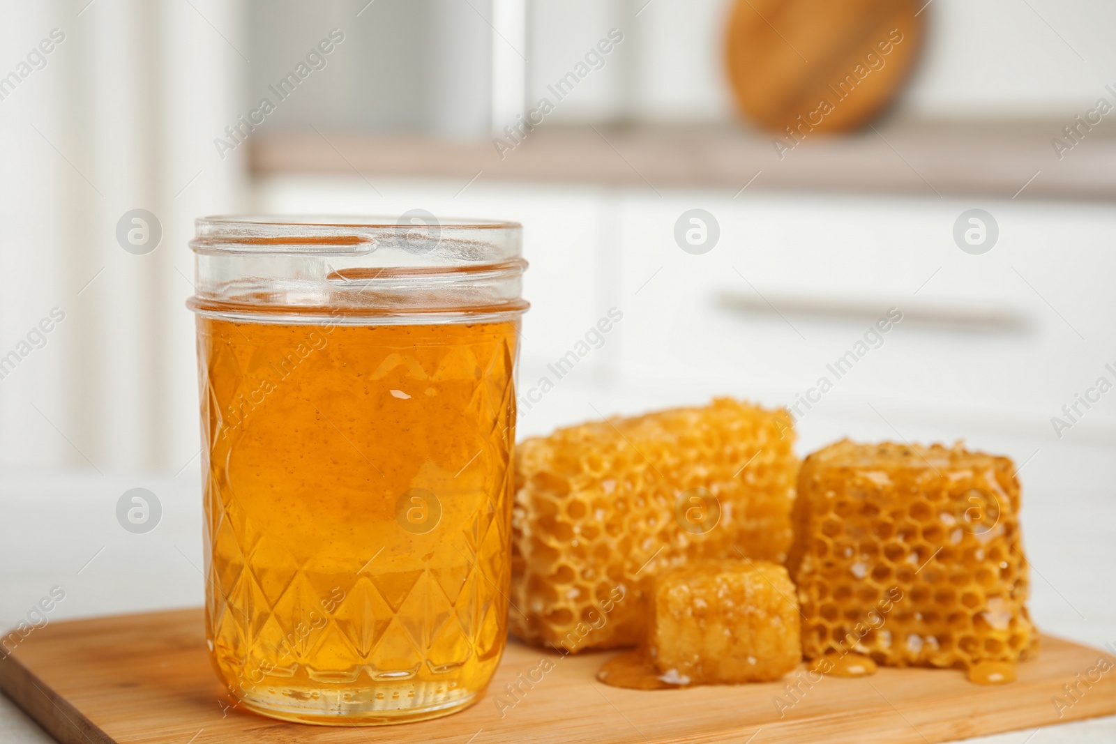 Photo of Composition with fresh honey on wooden board, closeup