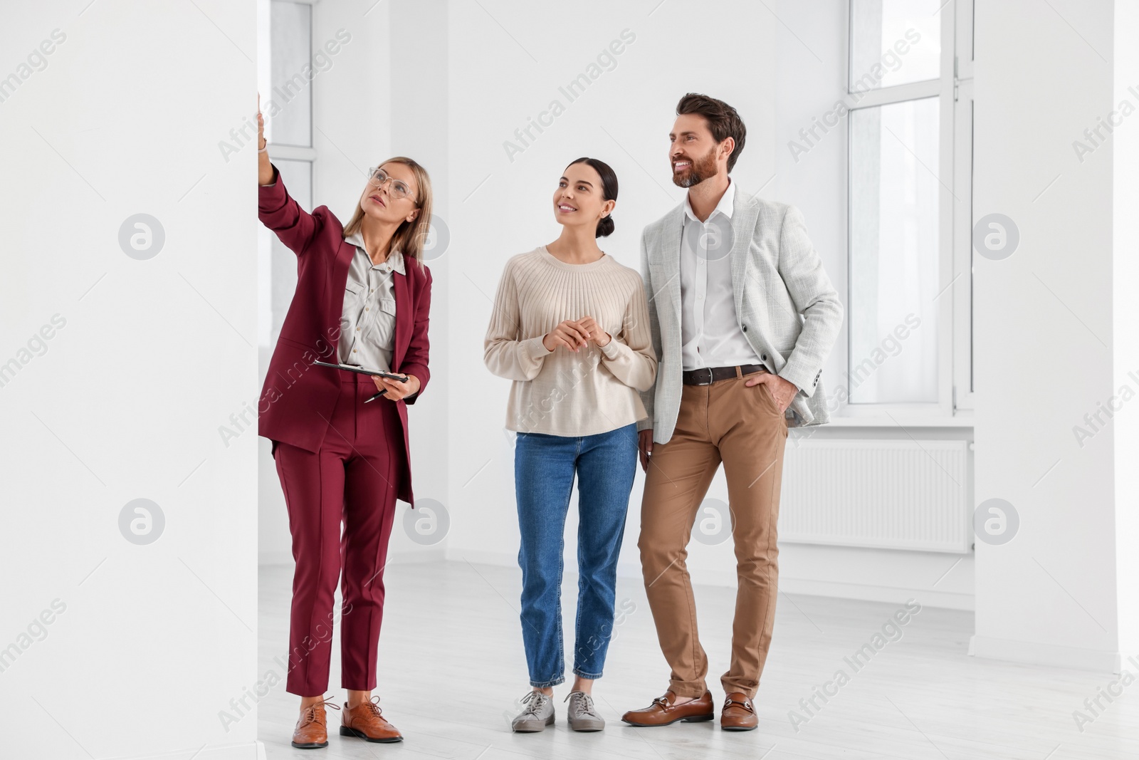 Photo of Real estate agent showing new apartment to couple