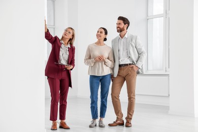 Photo of Real estate agent showing new apartment to couple