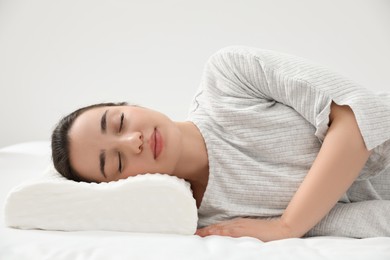 Photo of Woman sleeping on memory foam pillow indoors
