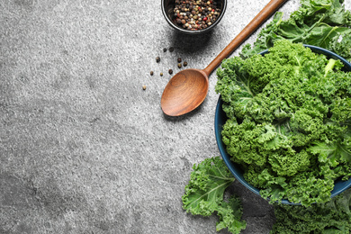 Photo of Fresh kale leaves and pepper on grey table, flat lay. Space for text