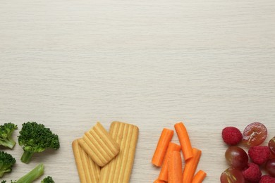 Photo of Different tasty baby finger foods on beige wooden table, flat lay. Space for text