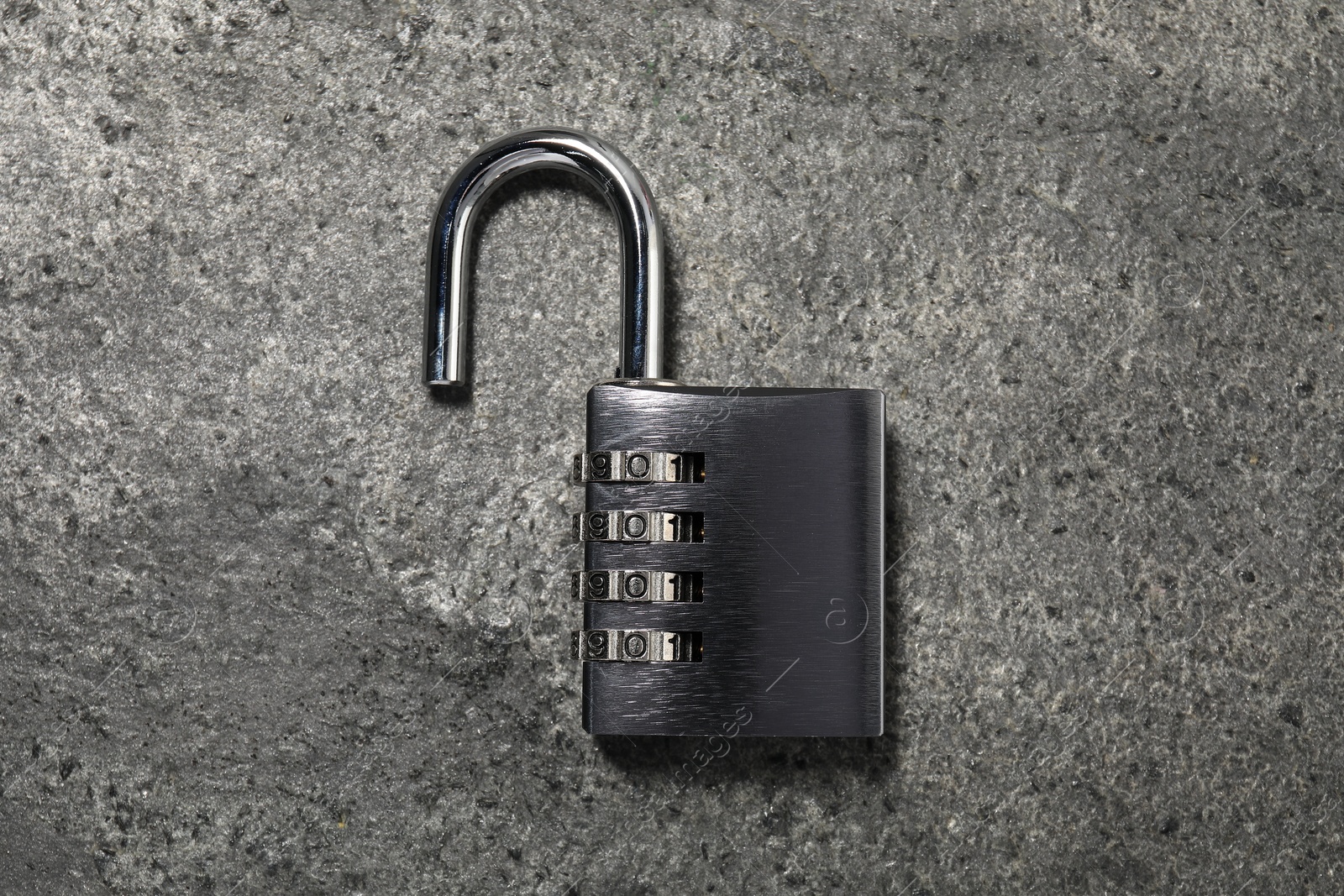 Photo of One steel combination padlock on grey table, top view