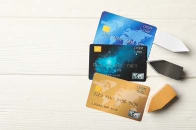 Photo of Flat lay composition with credit cards on white wooden background. Space for text