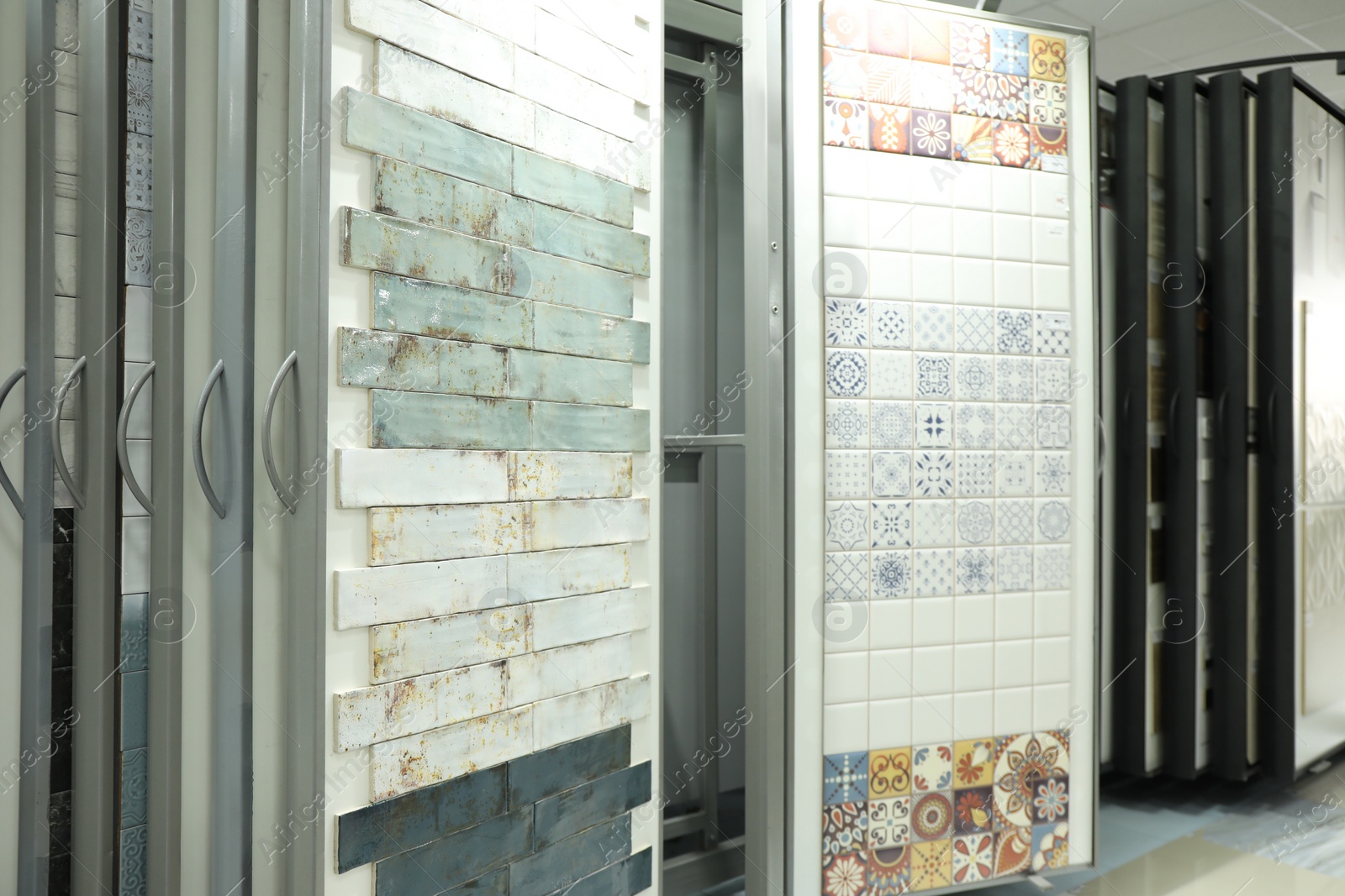 Photo of Assortment of tiles in store. Many different samples indoors