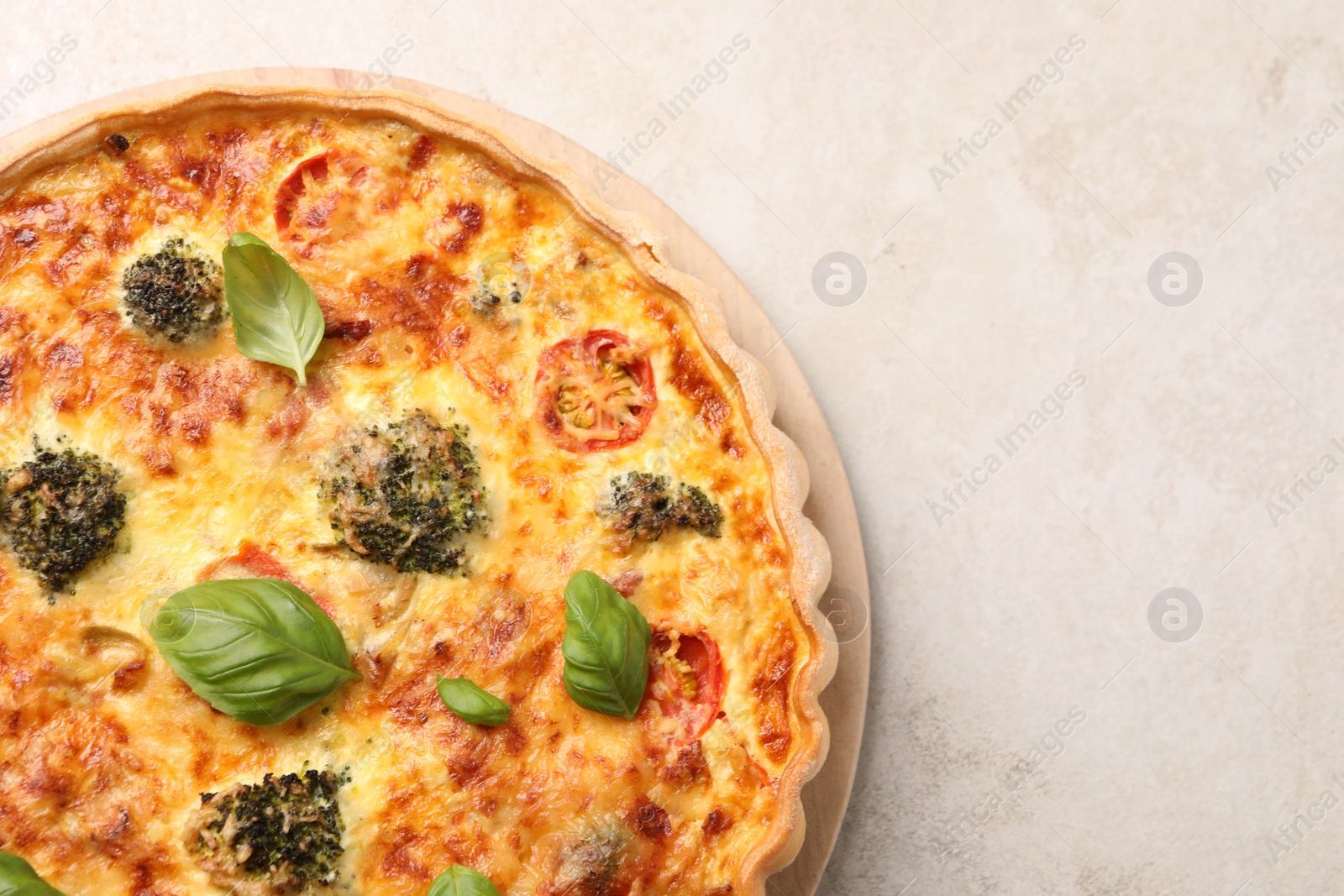 Photo of Delicious homemade vegetable quiche on light gray table, top view