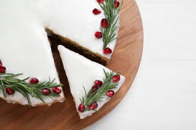 Photo of Traditional Christmas cake on white wooden table, top view