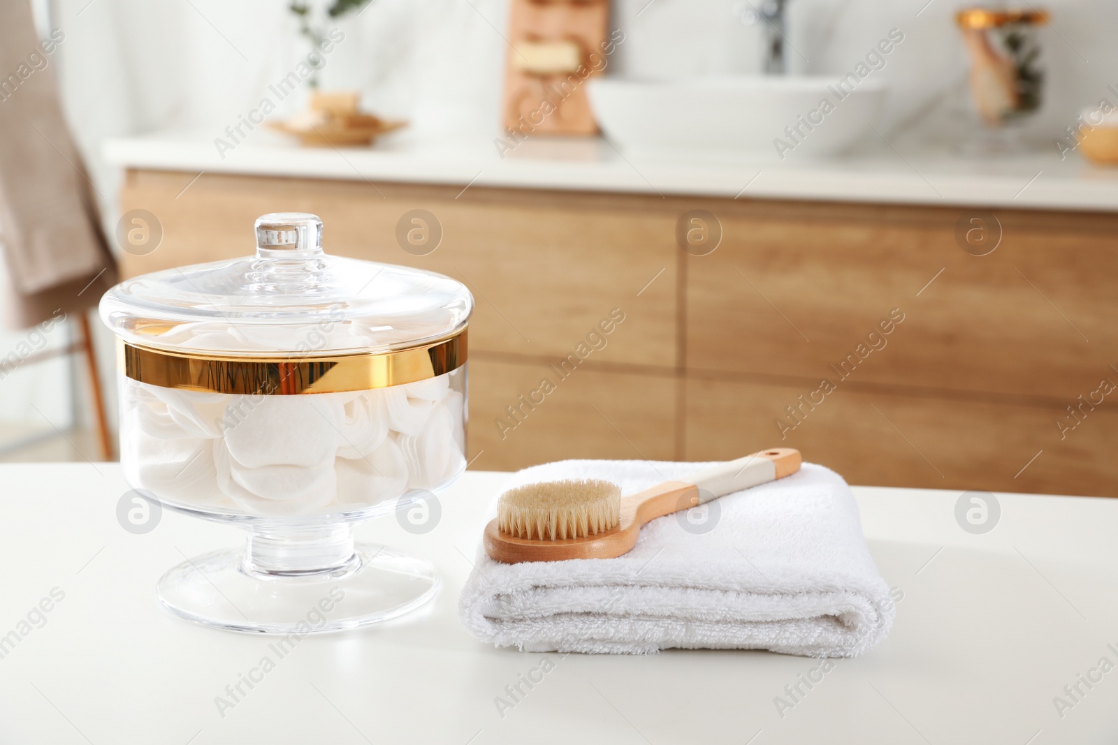 Photo of Jar with cotton pads on table in bathroom