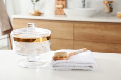 Photo of Jar with cotton pads on table in bathroom
