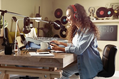 Photo of African American woman working as radio host in modern studio