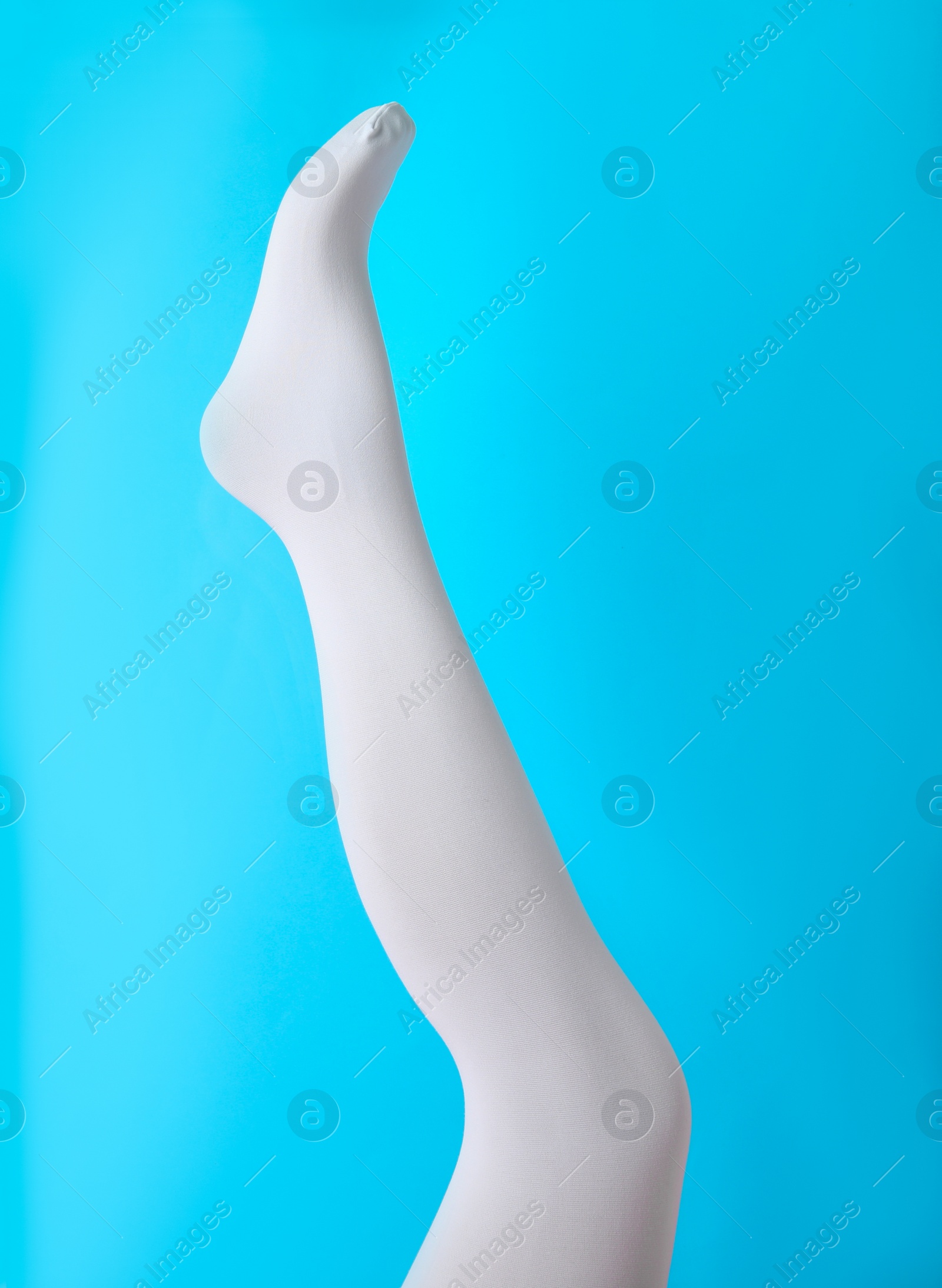 Photo of Leg mannequin in white tights on blue background