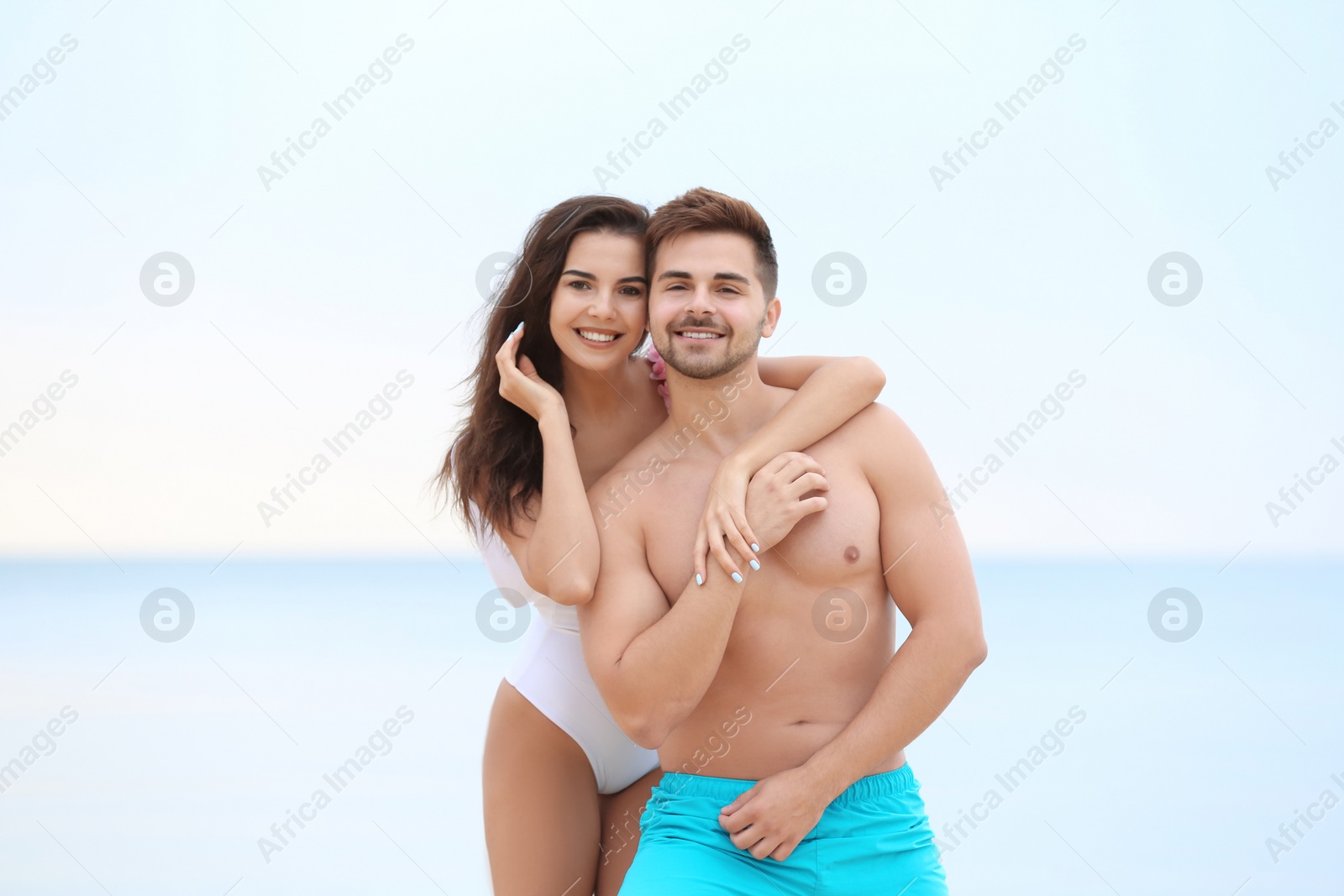 Photo of Happy young couple spending time together on beach