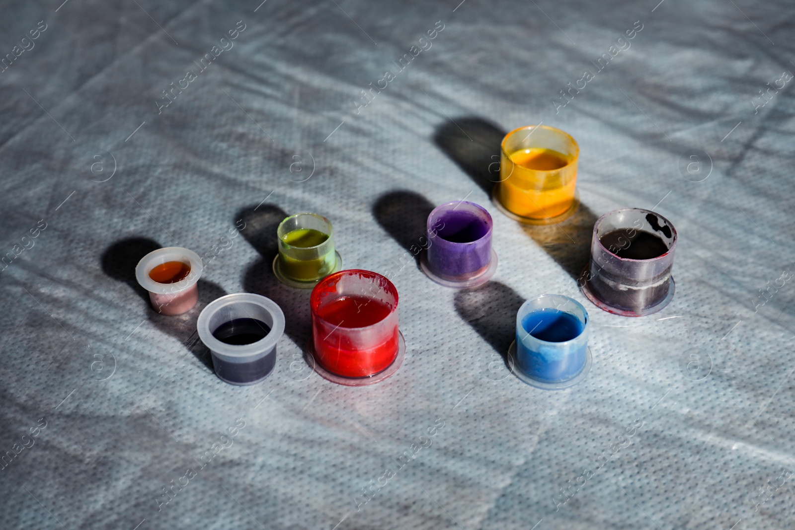 Photo of Caps with colorful tattoo inks on table