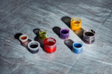 Photo of Caps with colorful tattoo inks on table