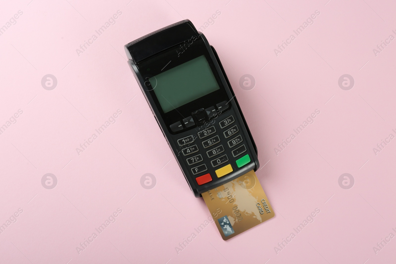 Photo of New modern payment terminal with credit card on pink background, top view