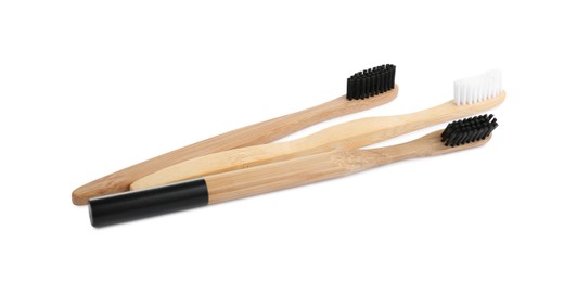 Photo of Natural bamboo toothbrushes with soft bristles isolated on white