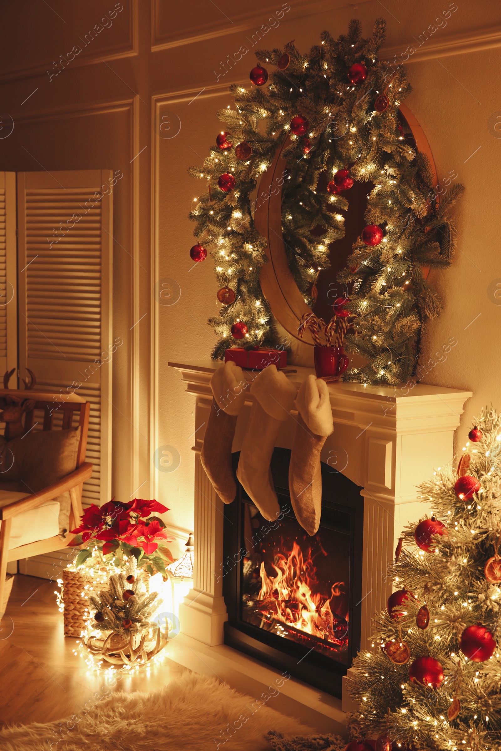 Photo of Fireplace with Christmas stockings in beautifully decorated living room