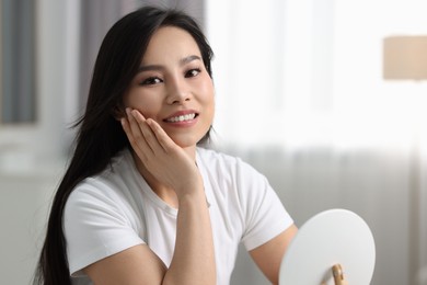 Portrait of beautiful woman with perfect skin at home, space for text