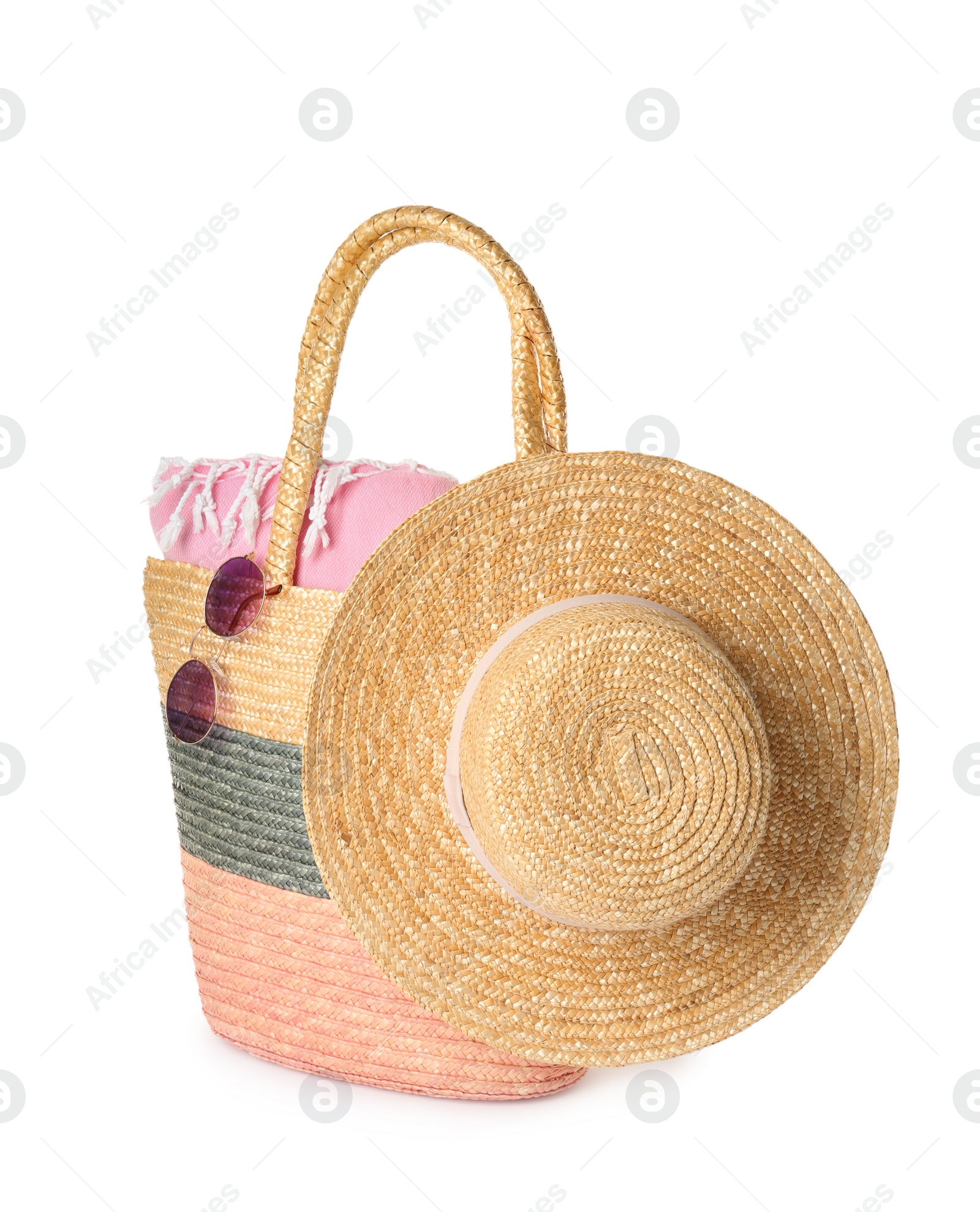 Photo of Stylish straw hat, beach bag and sunglasses on white background