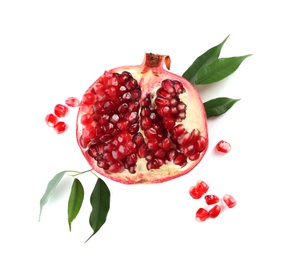 Ripe pomegranate with leaves on white background, flat lay