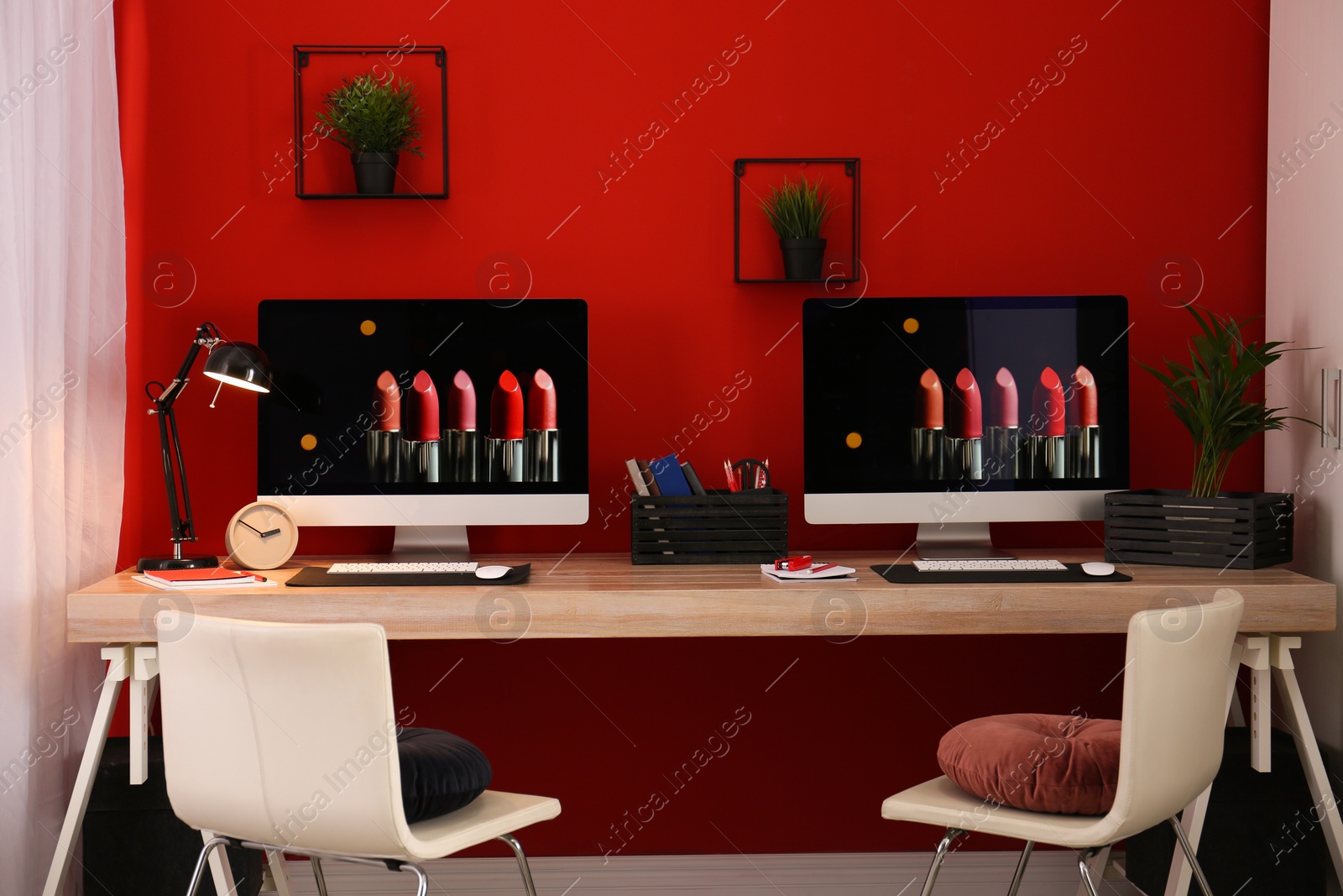 Photo of Modern workplace with large desk and computers in room. Stylish interior