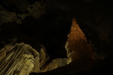 Photo of Many stalactite and stalagmite formations inside cave