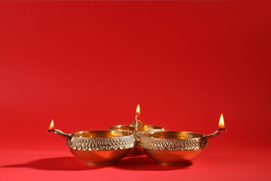 Photo of Diwali diyas or clay lamps on color background