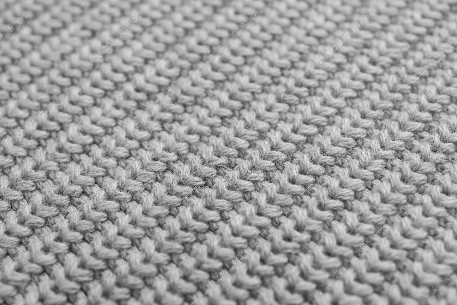 Photo of Grey knitted fabric as background, closeup view