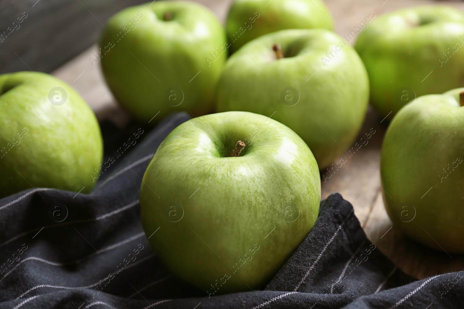 Photo of Fresh green apples on wooden table, closeup