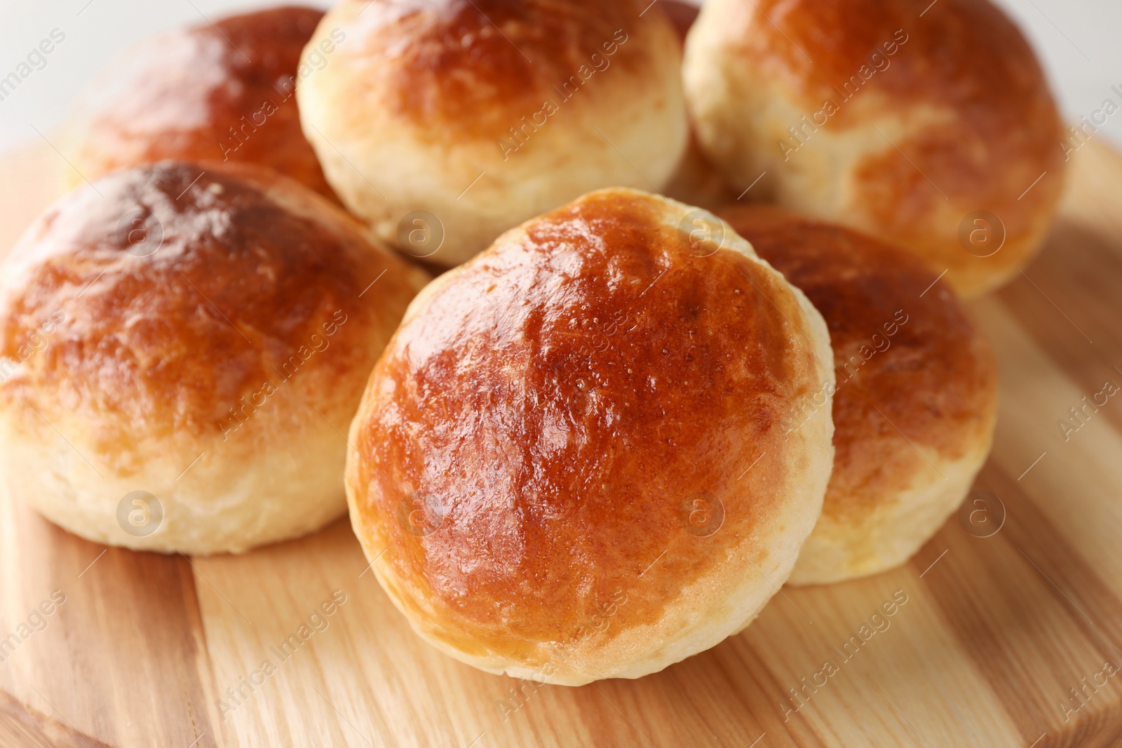 Photo of Tasty scones prepared on soda water on wooden board, closeup