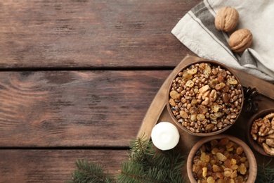 Photo of Traditional Christmas slavic dish kutia served on wooden table, flat lay. Space for text