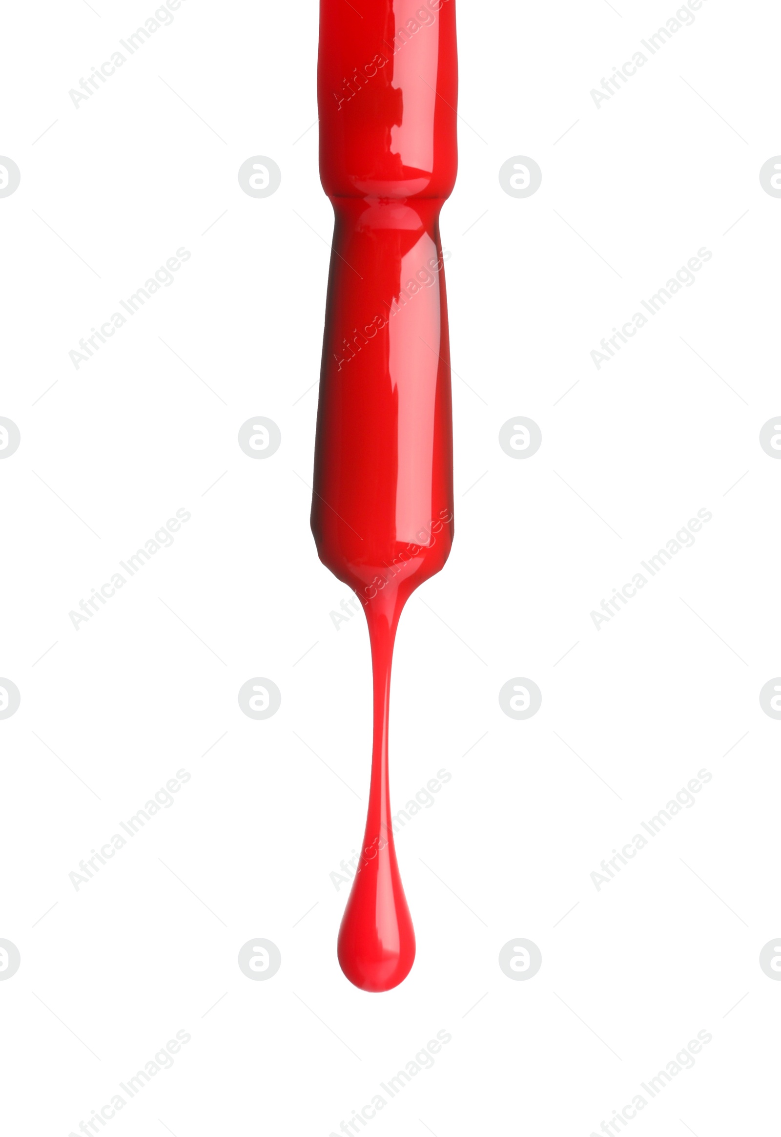 Photo of Red nail polish dripping from brush isolated on white