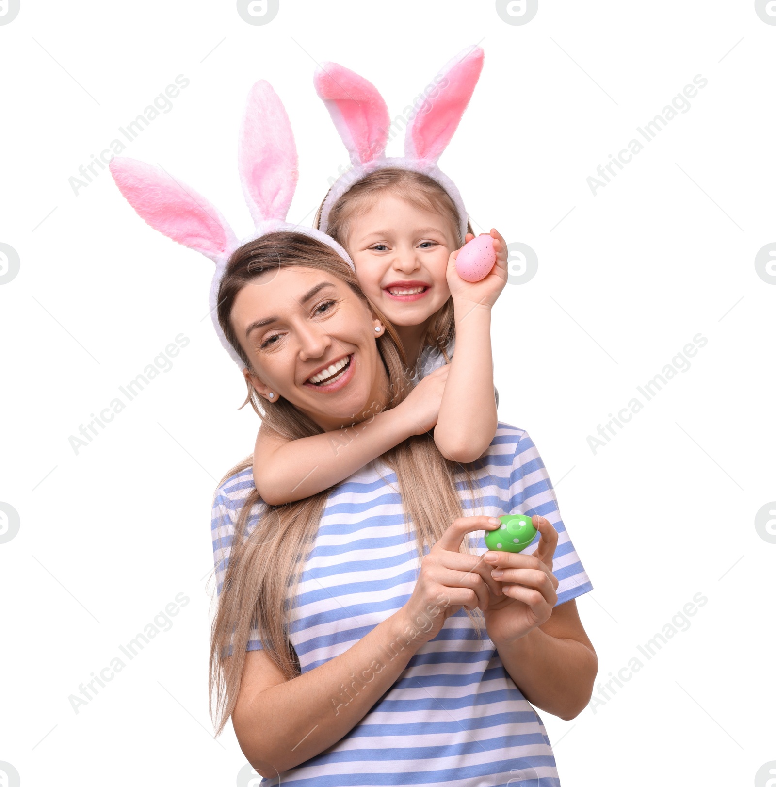 Photo of Easter celebration. Mother and her cute daughter with bunny ears and painted eggs isolated on white