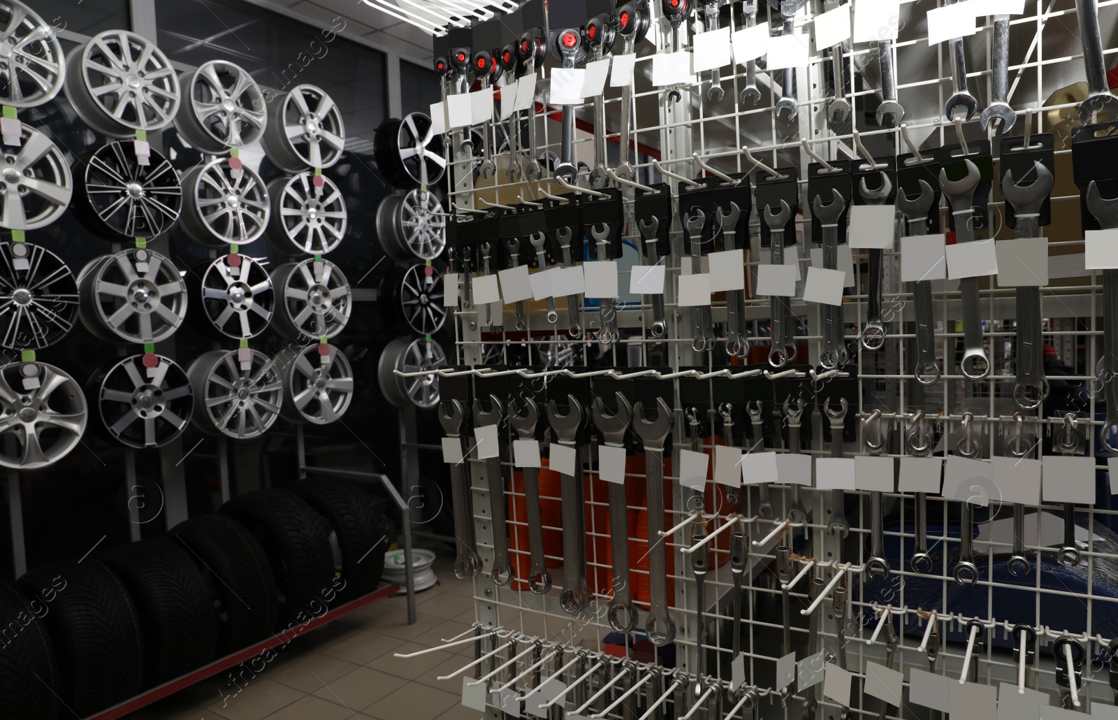 Image of Set of tools, alloy wheels and tires in auto store