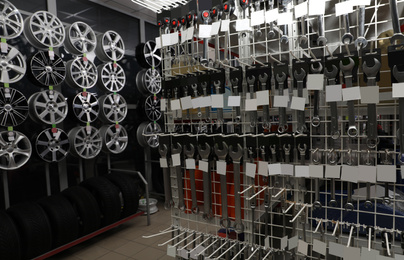 Set of tools, alloy wheels and tires in auto store