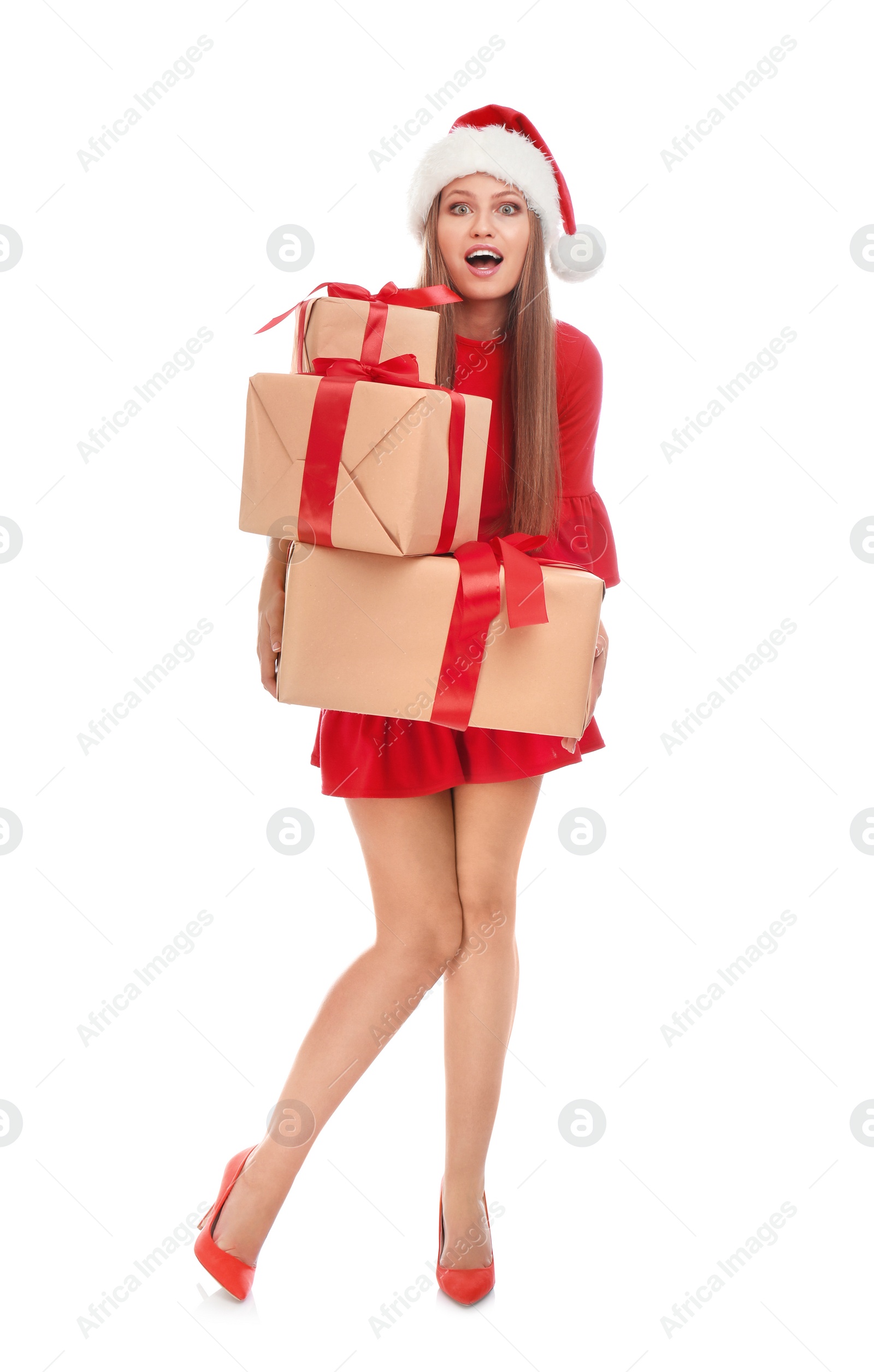 Photo of Emotional young woman in Santa hat with Christmas gifts on white background