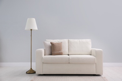 Photo of Simple room interior with comfortable white sofa