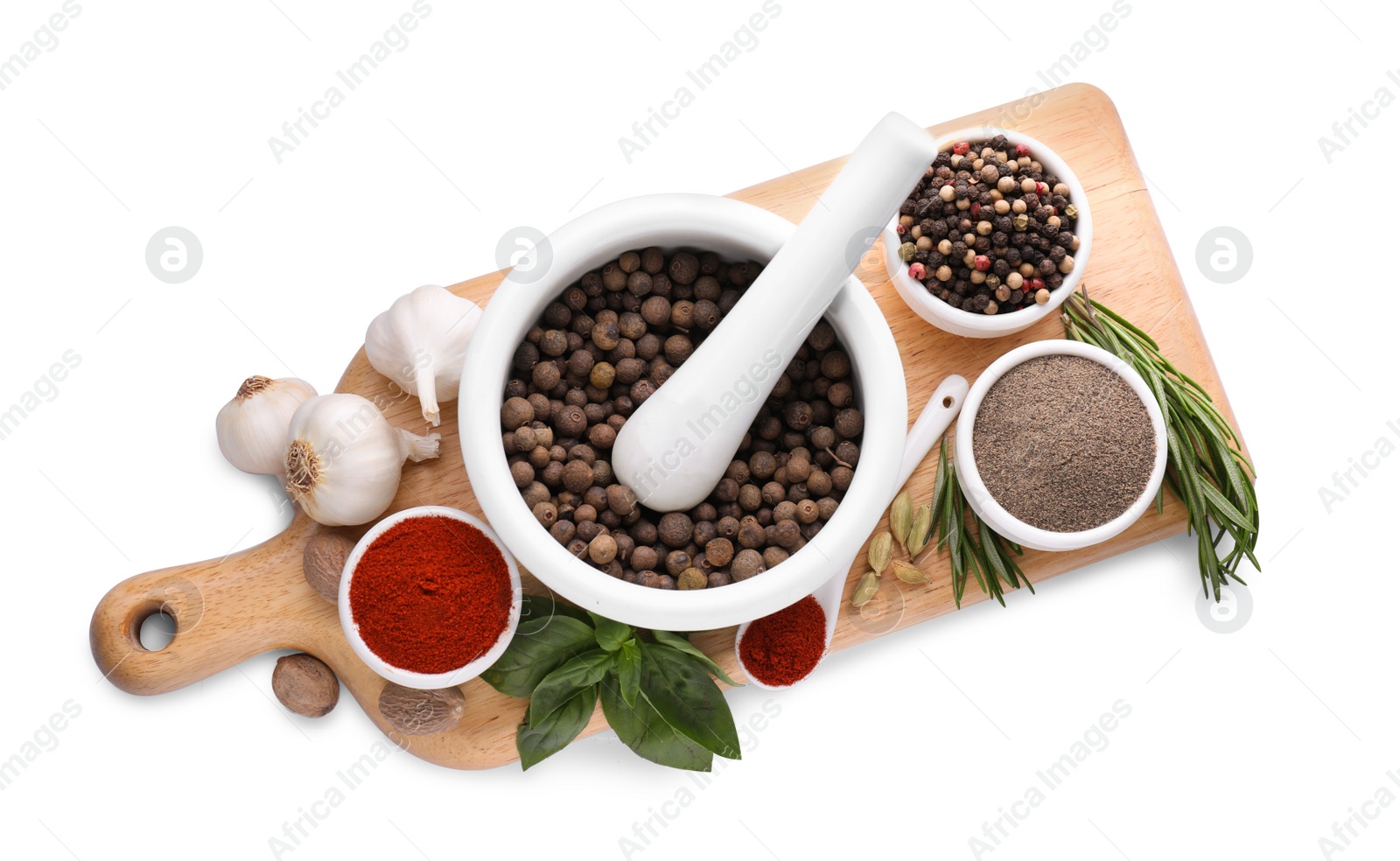 Photo of Mortar with pestle and different spices on white background, top view