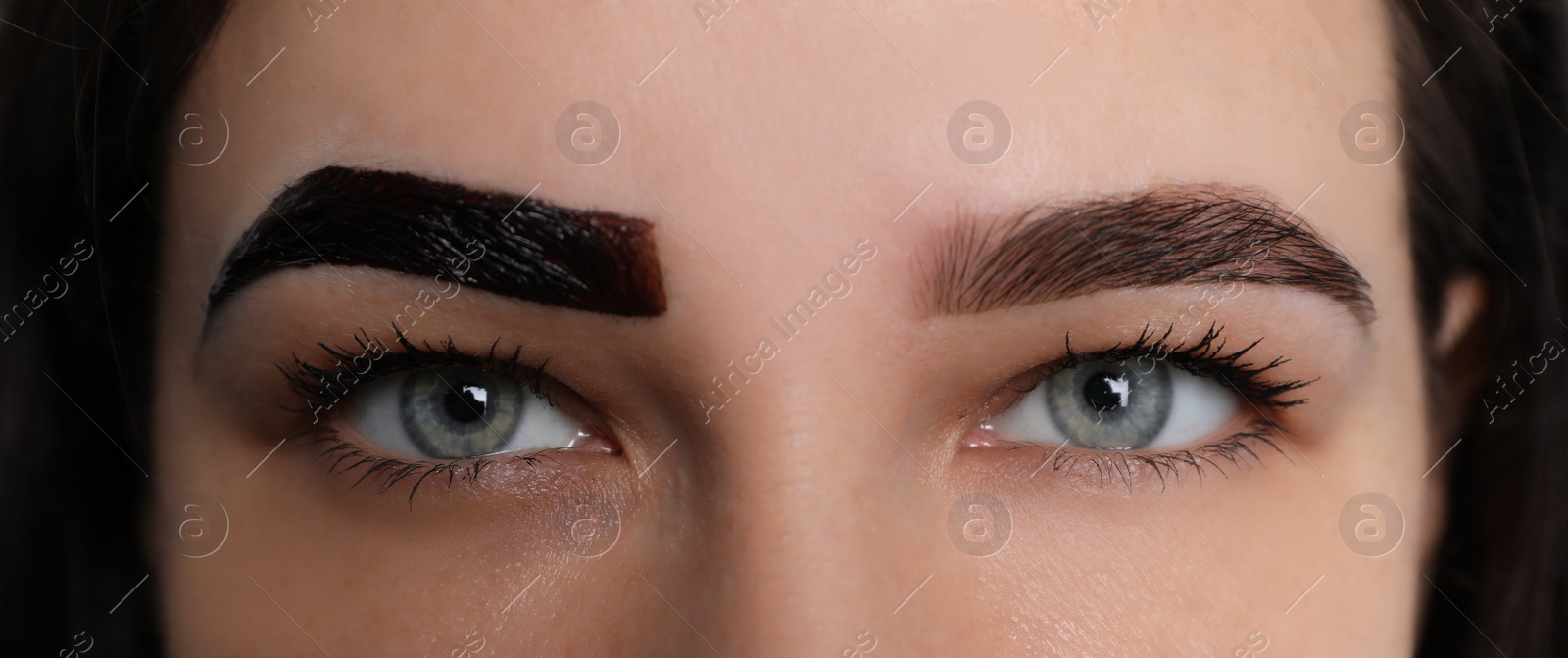 Photo of Woman during eyebrow tinting procedure, closeup view