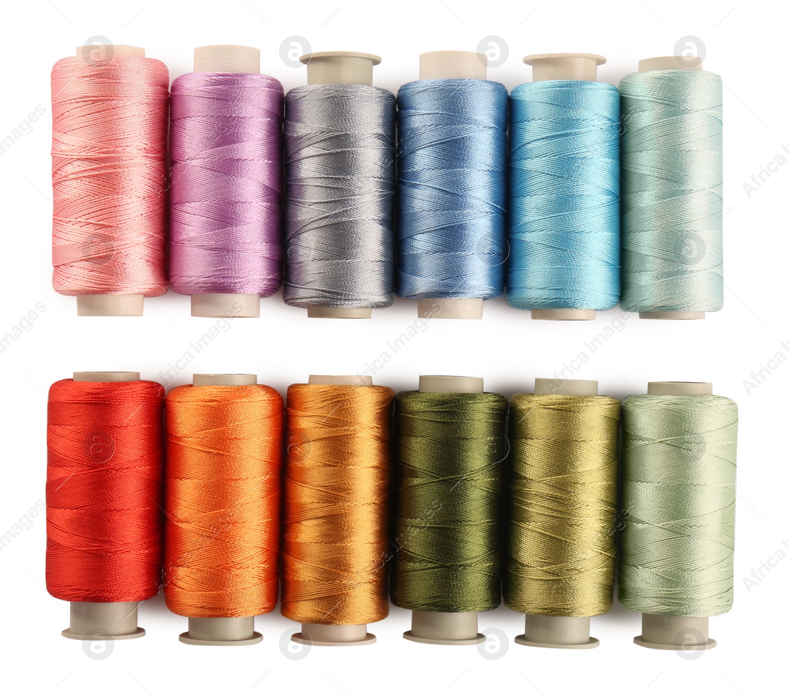 Photo of Set of colorful sewing threads on white background, top view