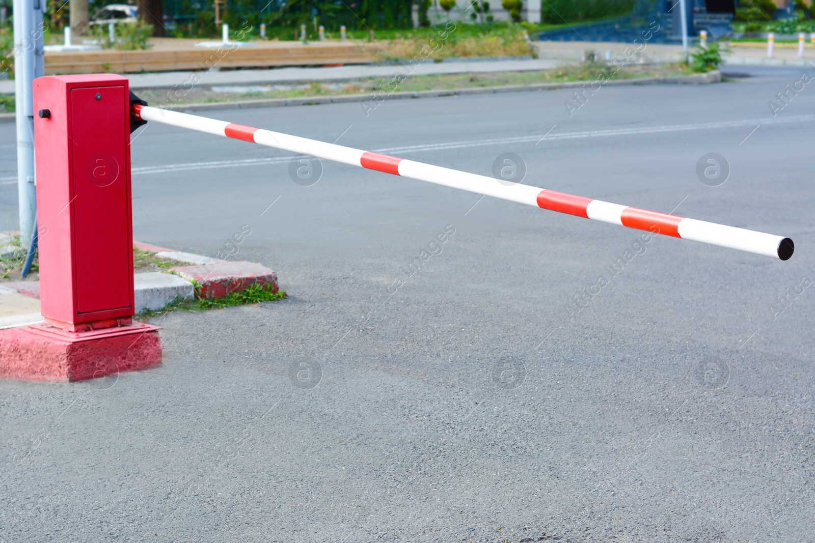 Photo of Closed boom barrier near road on autumn day outdoors