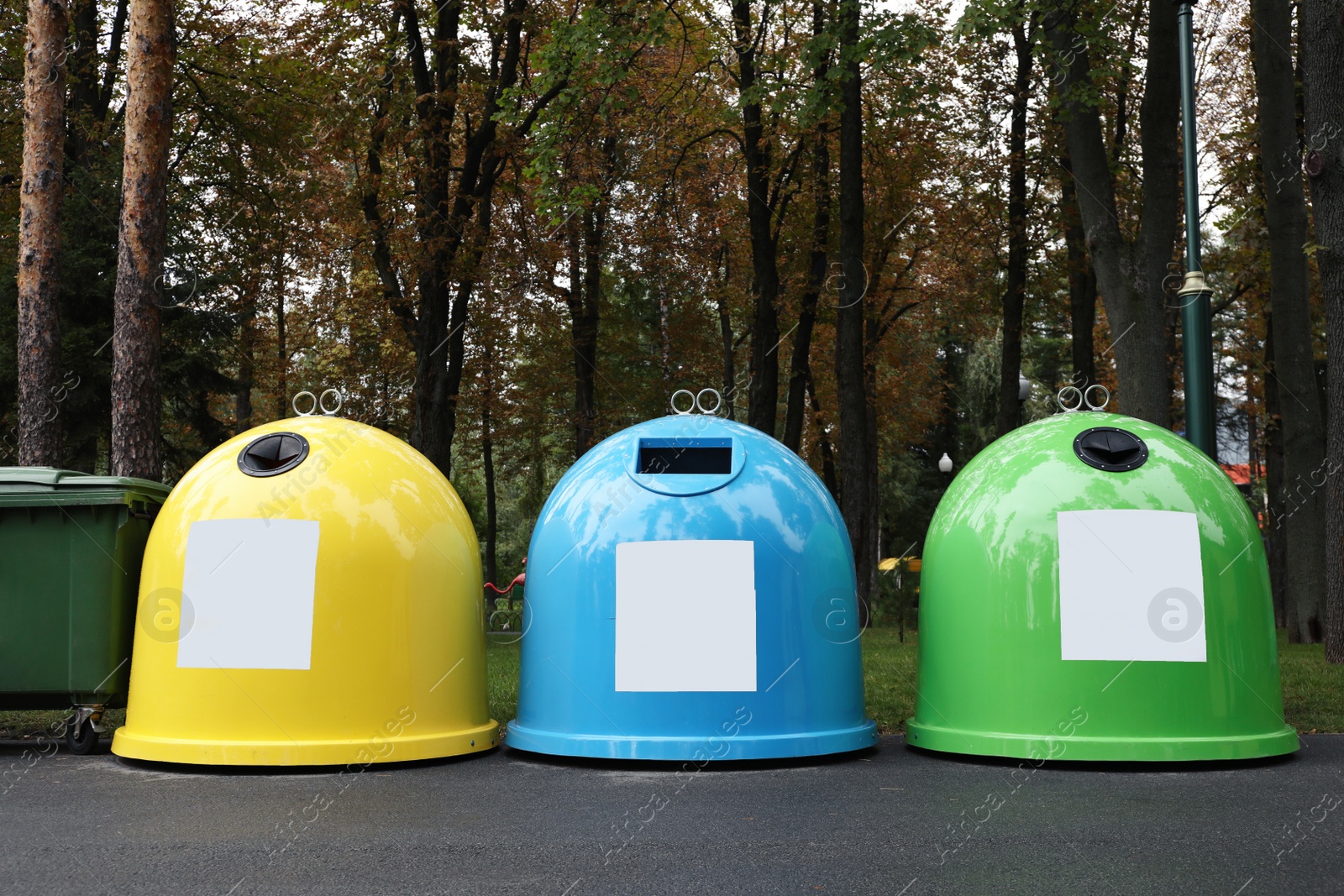 Photo of Waste sorting bins in park on autumn day