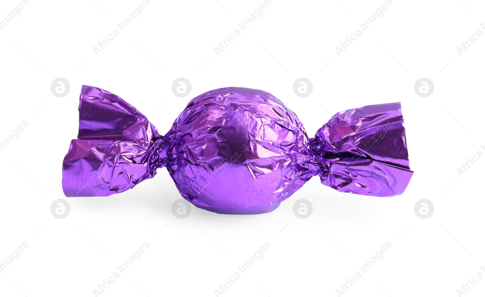 Photo of Tasty candy in purple wrapper isolated on white