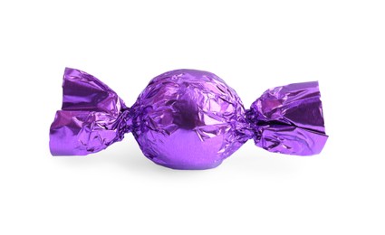 Tasty candy in purple wrapper isolated on white