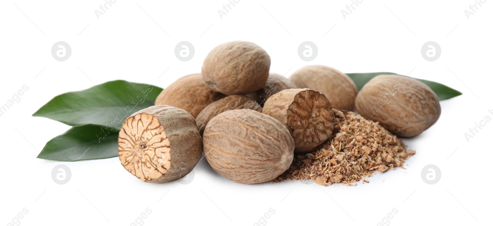 Photo of Grated nutmeg and seeds with green leaves on white background