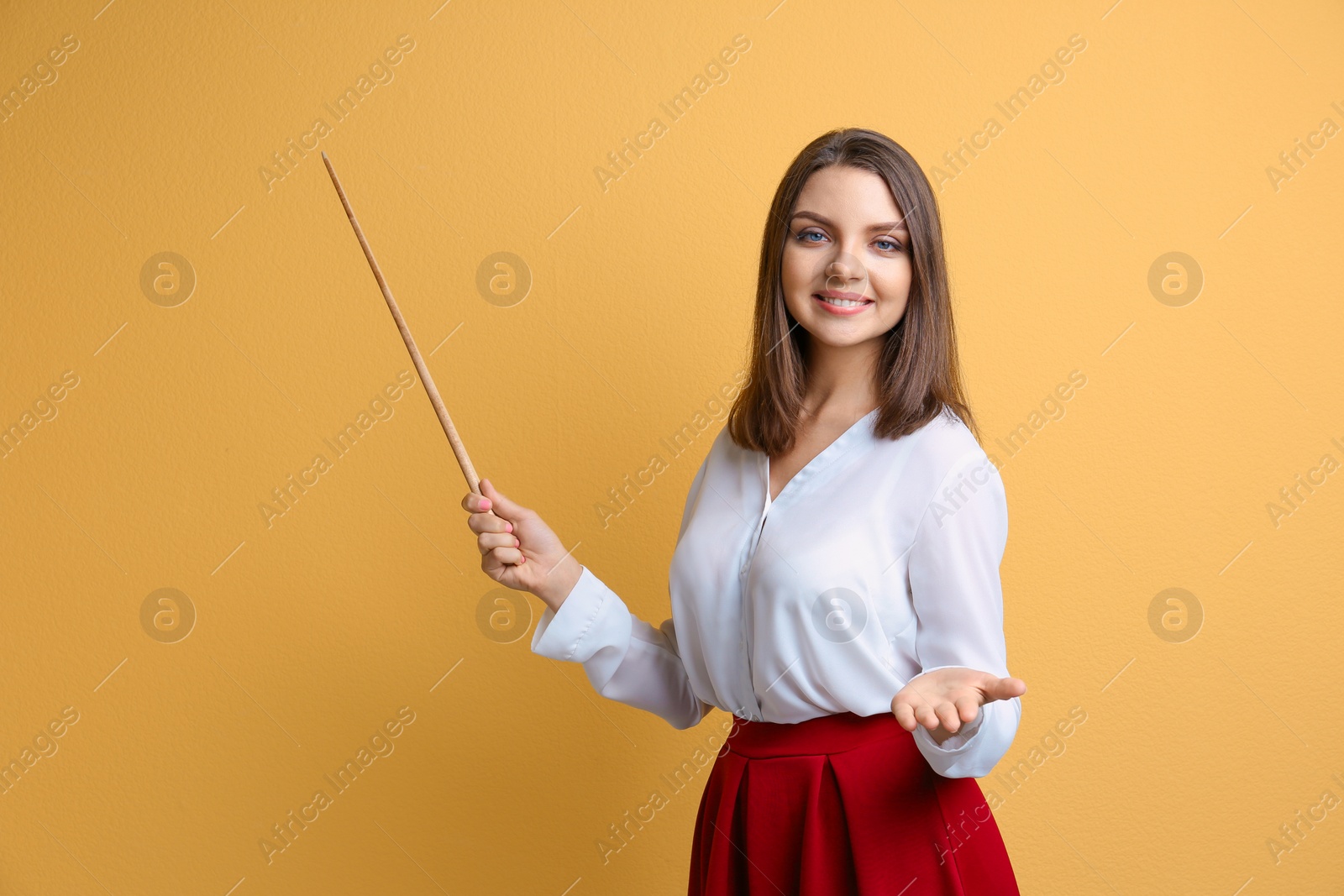 Photo of Portrait of female teacher with pointer on color background