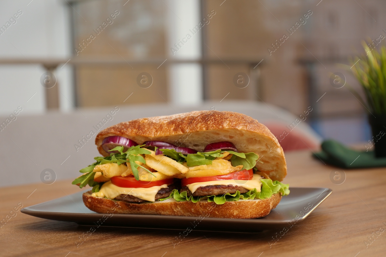 Photo of Plate with yummy sandwich on table in cafe